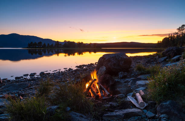 Campfire at a lake stock photo