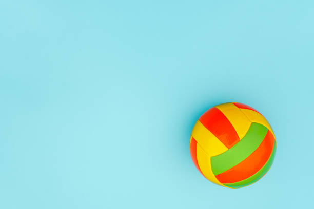 istock Bright multi-colored volleyball ball on blue background with copy space. Top view Flat lay Minimal style Template for card, design 1178265407