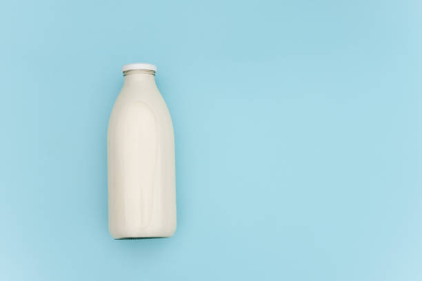 istock Milk in glass bottle on blue background with copy space. Flat lay Top view 1178265449