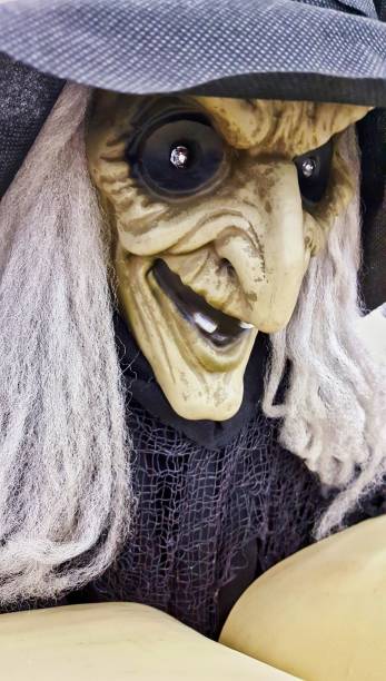 istock Witch Halloween decoration reading from a spell book. 1178266422