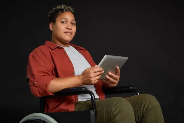 Photo of Disabled woman using tablet pc