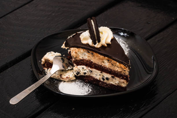 istock Eating creamy cheesecake with chocolate cookies and cream biscuits. 1178268284