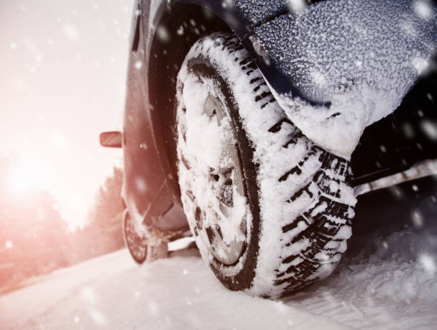 istock Car tires on winter road covered with snow 1178269361