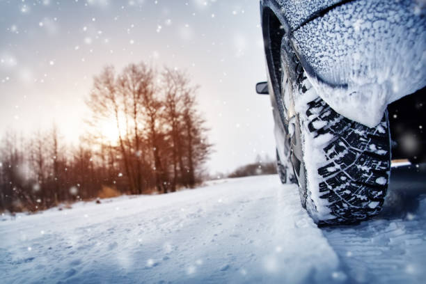 istock Car tires on winter road covered with snow 1178270034