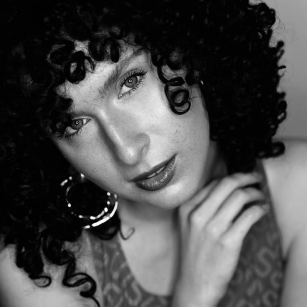 istock Beautiful young girl in a black curly wig 1178270043