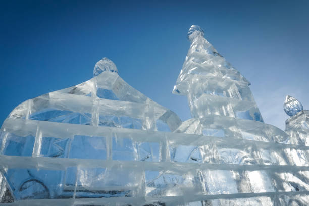 ice sculpture of the castle on a blue background in winter. Ice structures on the eve of the new year holiday decoration of the winter city