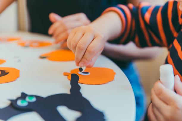 istock little boy making pumpkins head from paper 1178272472