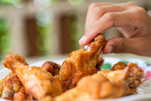istock Fried Chicken Wings picked up on hand 1178272875