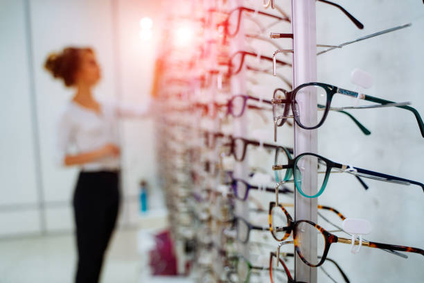istock Woman trying on glasses in optical store 1178275346