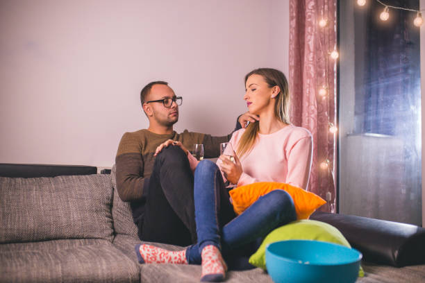 istock Couple chilling on the sofa with drinks 1178276551