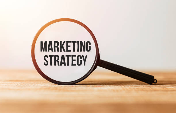 istock Magnifying glass with text Marketing Strategy on wooden table. 1178278002
