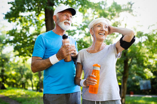 istock Beautiful senior couple running outside in forest 1178279834