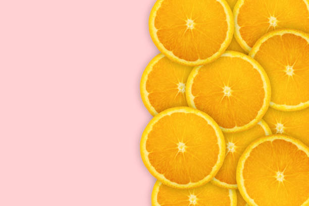 istock Slices of orange on pink background. Background and pattern concept 1178280513