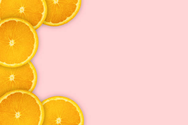 istock Slices orange on pink background. Background and pattern concept 1178280523