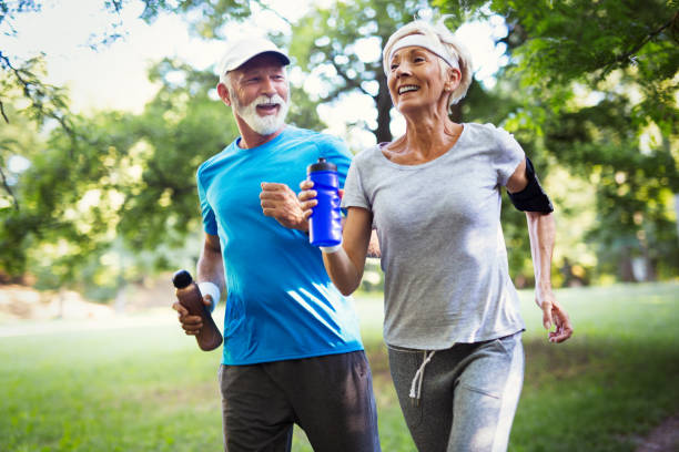 istock Beautiful senior couple running outside in forest 1178280600