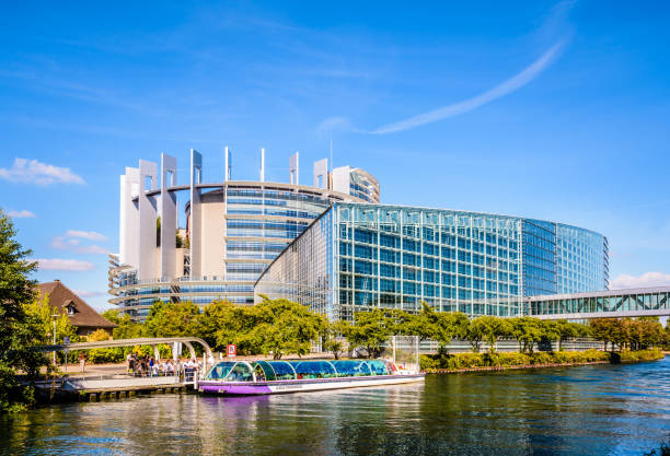 A tour boat is boarding tourists at the foot of the Louise Weiss building, seat of the European Parliament in Strasbourg, France. Strasbourg, France - September 13, 2019: A tour boat from Batorama company is boarding tourists at a station on the river Ill at the foot of the Louise Weiss building, seat of the European Parliament. campaign headquarters stock pictures, royalty-free photos & images