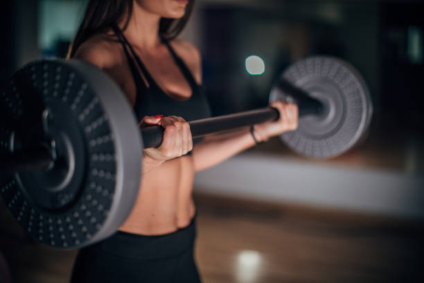 istock Fit woman practicing with weights in gym 1178284045