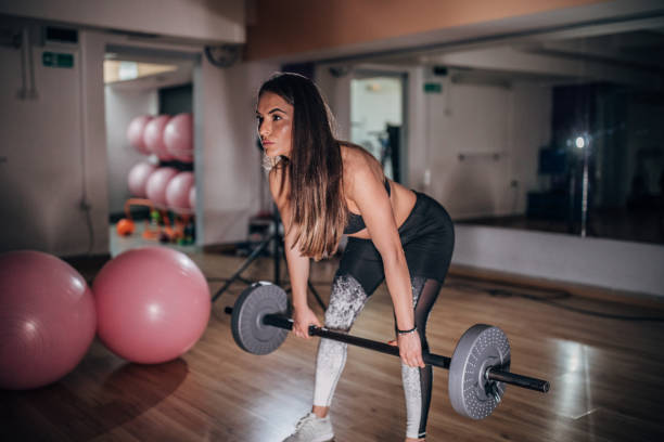 istock Fit lady training with weights in gym 1178284055