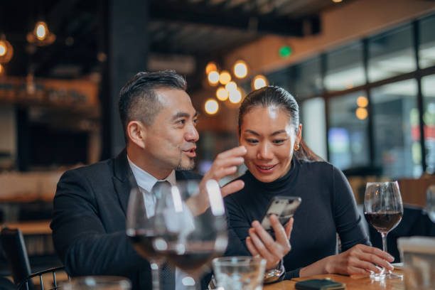 istock Gentleman and lady using smart phone in restaurant 1178285605