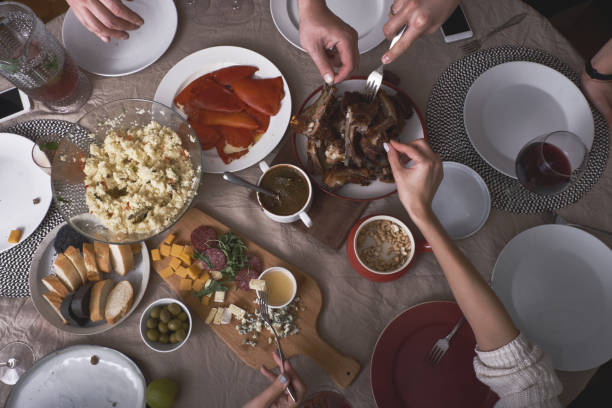 istock Hands of people having dinner in a big company 1178286919