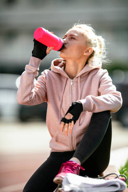 istock Young woman taking a break from jogging 1178288645