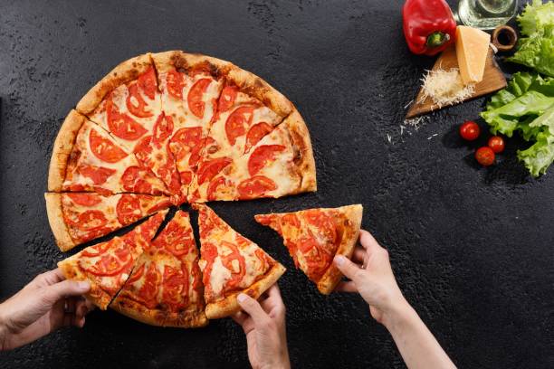 istock Pizza Margarita on a black background texture. Still life with hands and ingredients. Copy space. 1178289761