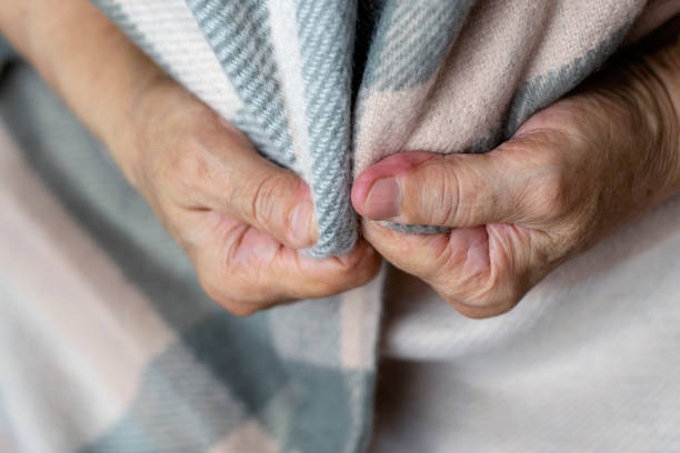 istock Feeling cold. Hands of elderly person feeling cold. 1178289890