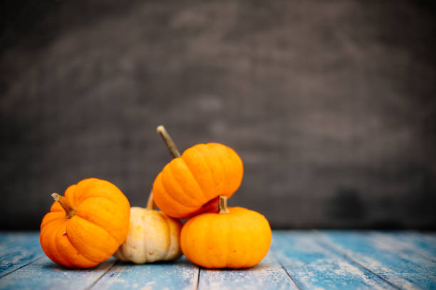 istock Mini Pumpkins on wooden table 1178290227