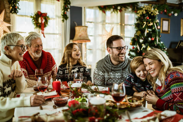 istock Happy extended family having fun during New Year's meal at dining table. 1178293027