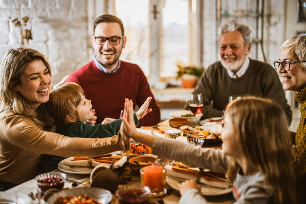 istock Happy extended family enjoying during lunch at dining table. 1178293106