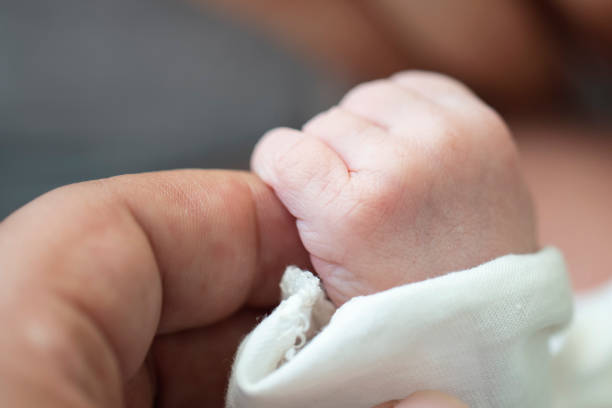 istock Baby Holding Mothers Hand 1178294135