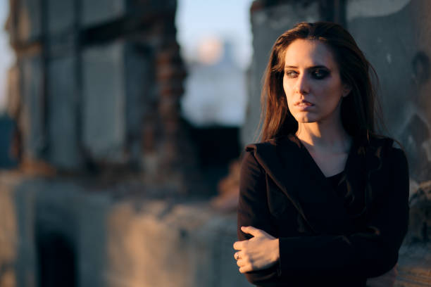 Domestic violence. Female discrimination. Abuse fear. Portrait of disturbed scared anxious insecure woman with beautiful face alone in dark shade.