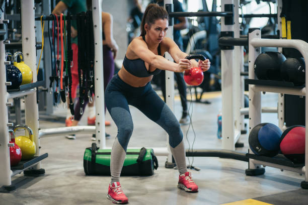 istock Young woman doing kettlebell exercises at gym 1178294418
