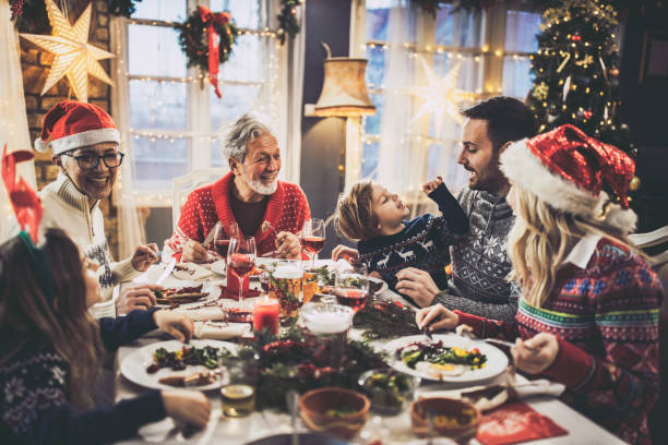 istock Happy extended family talking during New Year's meal at dining table. 1178294689