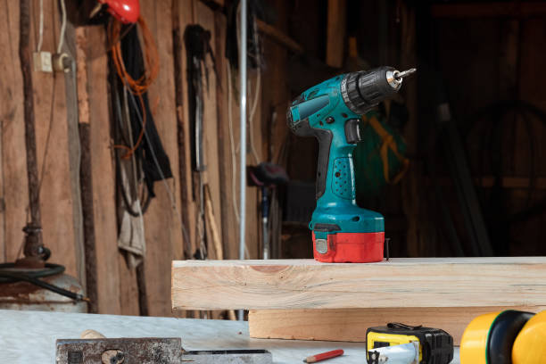 istock A man carpenter twists a screw into a tree with an electric screwdriver, male hands with a screwdriver close-up. Work with wood. 1178295456