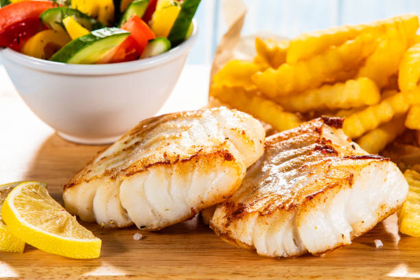 istock Fried cod fillet with French fries and vegetables 1178295950