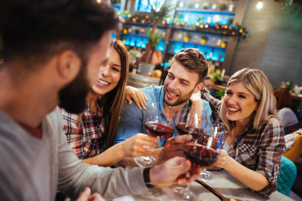 istock Group of friends toasting with red wine in a restaurant 1178296484