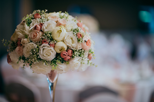 Close-up of colorful floral wedding bouquet consisting of numerous flower types, bundled up into a small bunch for handheld purposes.