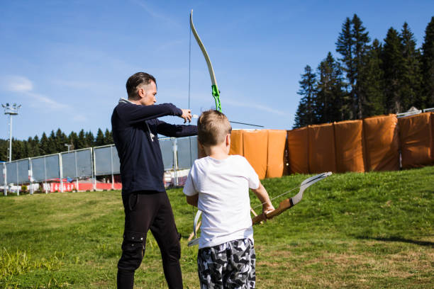 istock Father and son practicing archery outdoors. 1178298955