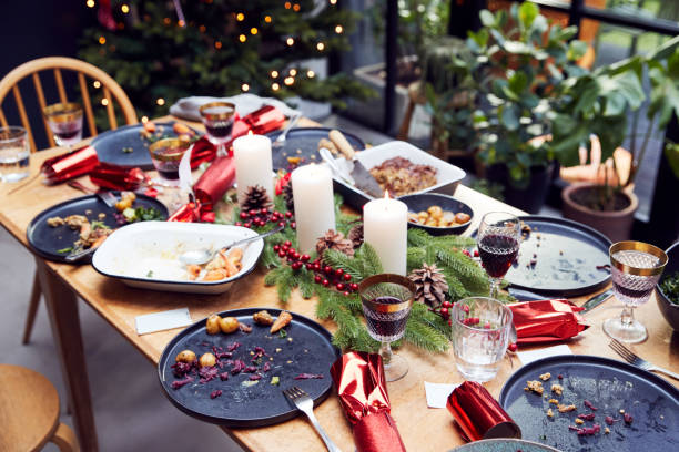 Messy Table With Leftover Vegetarian Meal After Christmas Lunch Messy Table With Leftover Vegetarian Meal After Christmas Lunch leftovers photos stock pictures, royalty-free photos & images