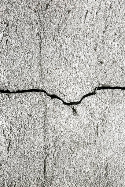 istock Concrete wall with a crack on it. Grey texture background. 1178300522