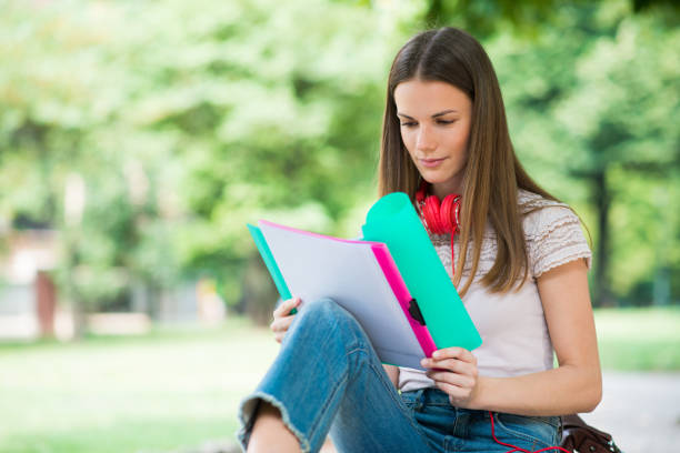 istock Student studying in a park in front of the school 1178301697