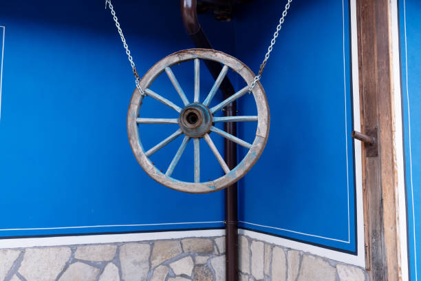 Very old metal wheel attached to a wall for decoration