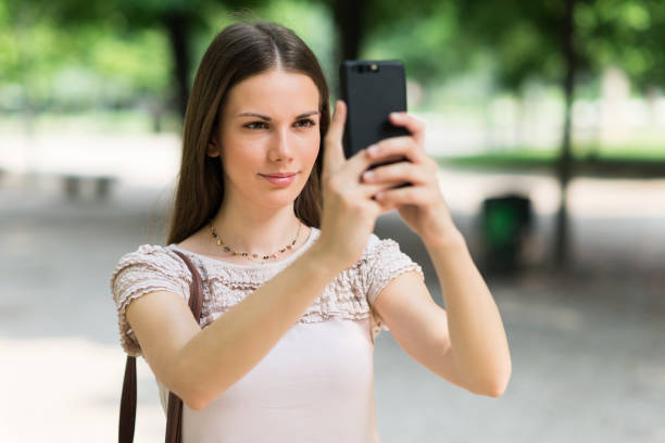 istock Young woman using her mobile phone to take a photo 1178301997