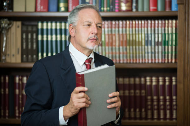 istock Businessman holding a book in a library 1178302918