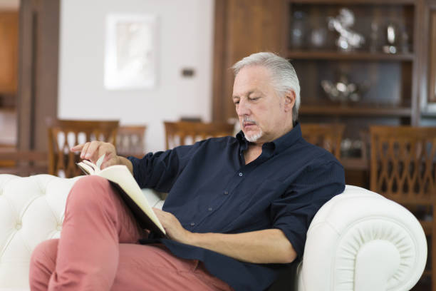 istock Portrait of a mature man reading a book 1178303390