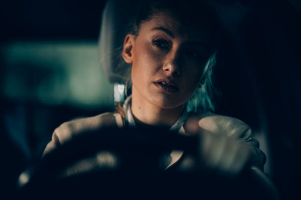 istock Young woman driving at late night 1178303443