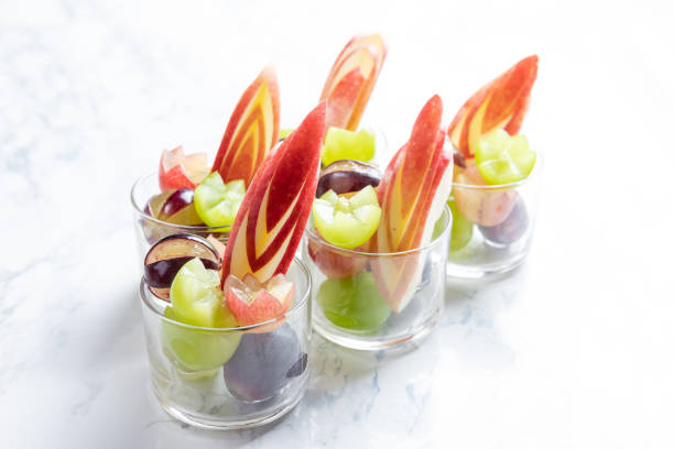 istock Glass cups filled with ripe juicy grapes on table 1178303499