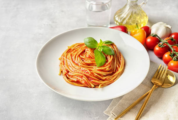 istock Pasta with tomato sauce and basil on white background 1178303536