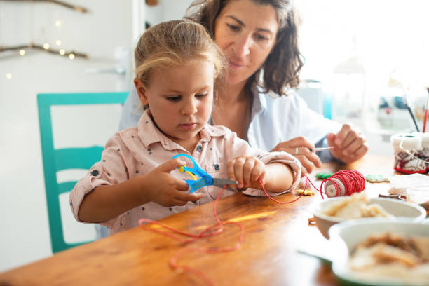 istock Mother and Daughter making Christmas ornaments 1178308171